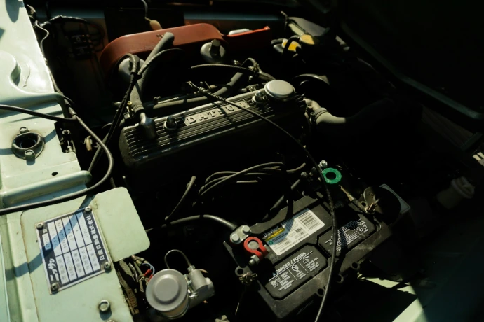 Close-up of a car engine and battery.